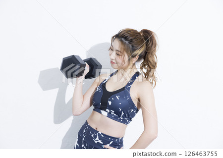 Women training on dumbbells Women training on dumbbells 126463755