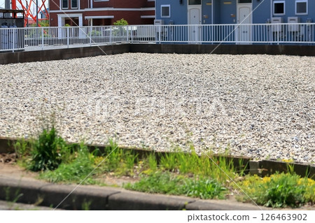 A vacant lot covered with gravel 126463902