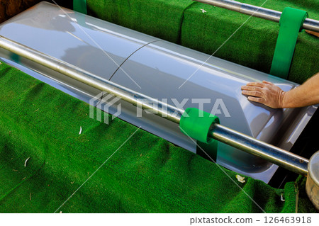 Man, secures coffin outdoors near hearse serious mood reflects gravity of moment during funeral preparation Man, secures coffin outdoors near hearse serious mood reflects gravity of moment during funeral preparation 126463918