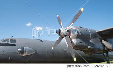 A vintage Soviet aircraft stands proudly under a clear blue sky, highlighting its unique propeller design and signifying the rich aviation history of Russia. A vintage Soviet aircraft stands proudly under a clear blue sky, highlighting its unique propeller design and signifying the rich aviation history of Russia. 126464072