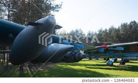A collection of vintage Soviet aircraft exhibits in Russia, featuring unique designs and military technology set against a backdrop of trees and grass. A collection of vintage Soviet aircraft exhibits in Russia, featuring unique designs and military technology set against a backdrop of trees and grass. 126464081