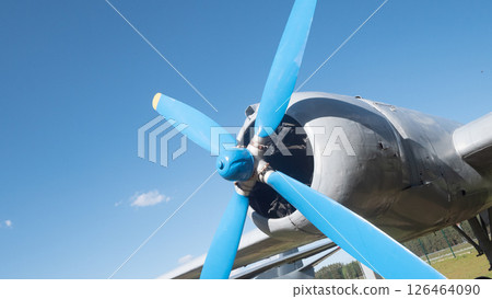 Close-up view of a vintage aircraft propeller set against a vibrant blue sky, highlighting the craftsmanship of Soviet aviation from the mid-20th century. Close-up view of a vintage aircraft propeller set against a vibrant blue sky, highlighting the craftsmanship of Soviet aviation from the mid-20th century. 126464090