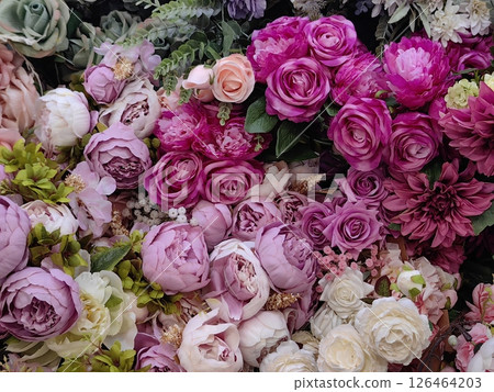 beautiful assortment artificial flowers in shades pink and purple decoration. closeup. beautiful assortment artificial flowers in shades pink and purple decoration. closeup. 126464203