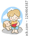 Enjoy some delicious watermelon! A boy eating watermelon with his dog on a rock by the sea 126464387