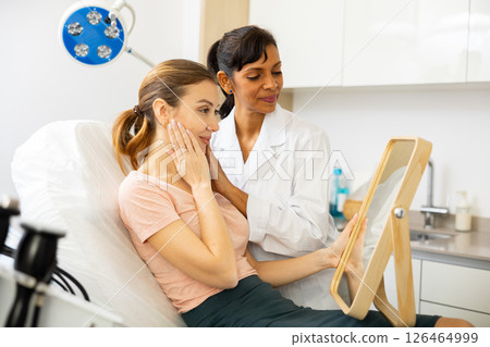 Woman satisfied after received cosmetological procedure Woman satisfied after received cosmetological procedure 126464999