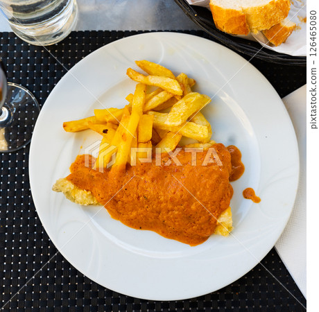 Piece of fried cod fillet covered with pureed thick escalivada sauce Piece of fried cod fillet covered with pureed thick escalivada sauce 126465080