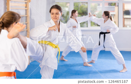 Females in kimono practicing fighting moves 126465187