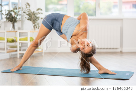 Young woman practicing hatha yoga in studio 126465343
