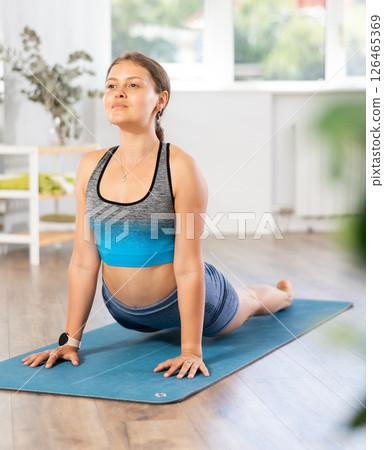 Experienced woman yoga trainer performing different youga pose on mat Experienced woman yoga trainer performing different youga pose on mat 126465369