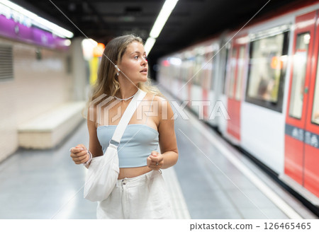 Young girl standing in platform with wireless headphones on airs Young girl standing in platform with wireless headphones on airs 126465465