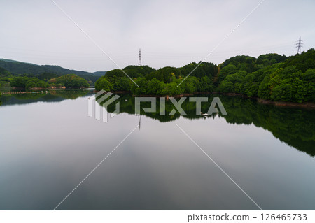 奈良縣奈良市佈目水壩，薄薄的雲層中透出的陽光，倒映在如鏡的湖面上，映照著天空② 126465733