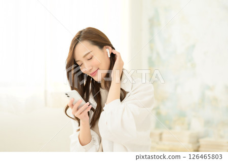 A woman listening to music A woman listening to music 126465803