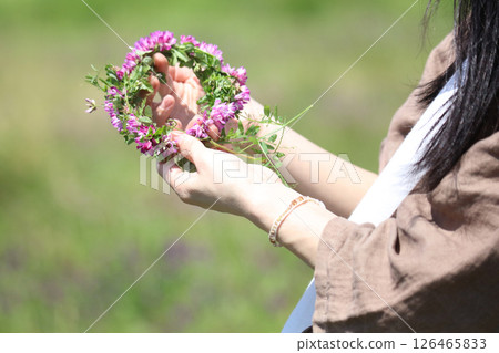 Woman making a flower crown Woman making a flower crown 126465833
