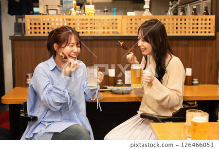 A woman drinking alcohol at the bar counter A woman drinking alcohol at the bar counter 126466051