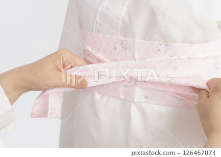 The process of putting on a formal kimono 126467073