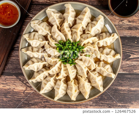 A plate of dumplings arranged on a platter 126467526