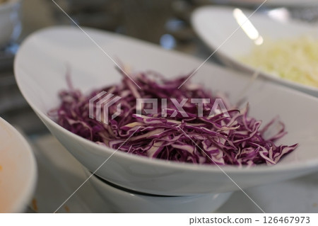 Shredded purple cabbage on wooden cutting board Shredded purple cabbage on wooden cutting board 126467973
