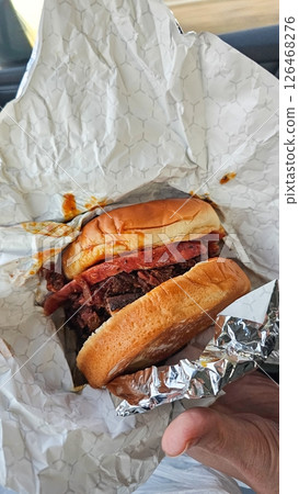 Delicious Pulled Pork Sandwich in Paper Wrapper, Ready to Eat, Perfect for Lunch or Dinner Delicious Pulled Pork Sandwich in Paper Wrapper, Ready to Eat, Perfect for Lunch or Dinner 126468276