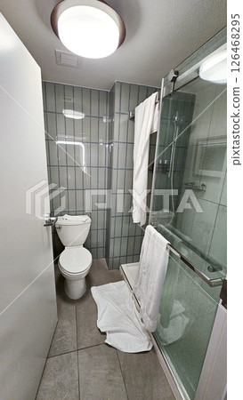 Modern Bathroom Interior with Toilet, Shower, and Towels, Perfect for Real Estate Ads Modern Bathroom Interior with Toilet, Shower, and Towels, Perfect for Real Estate Ads 126468295