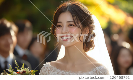 A joyful bride smiles radiantly on her wedding day surrounded by family and friends. 126468791