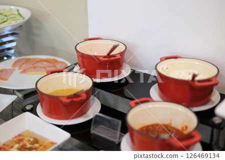 sauces in small red pots serving various toppings before meals at buffet sauces in small red pots serving various toppings before meals at buffet 126469134
