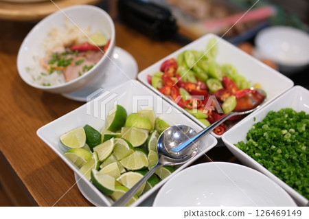 ingredients for vietnamese pho bo soup. bowl with chopsticks, spoon. Space for text. Top view. Asian soup Pho bo on wooden table background. Vietnamese soup 126469149
