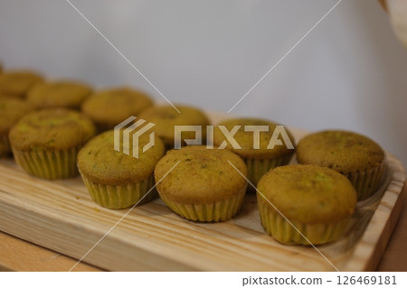 Home made Spinach and parmesan cheese muffins, served over white tray Home made Spinach and parmesan cheese muffins, served over white tray 126469181