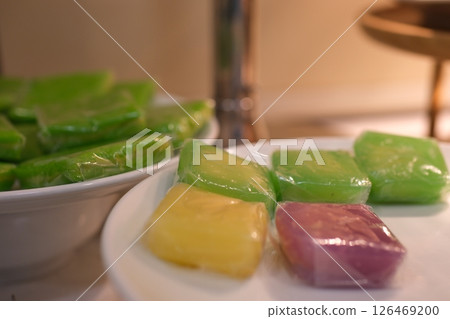 Colorful wrapped sweets traditional food tape uli and black sticky rice, Indonesian Sweet and savory dessert, Tape is made of fermented black glutinous rice, glutinous rice cake wrapped Colorful wrapped sweets traditional food tape uli and black sticky rice, Indonesian Sweet and savory dessert, Tape is made of fermented black glutinous rice, glutinous rice cake wrapped 126469200