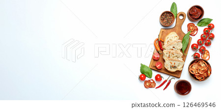 The concept of Italian cuisine, sun-dried tomatoes on a light background. 126469546