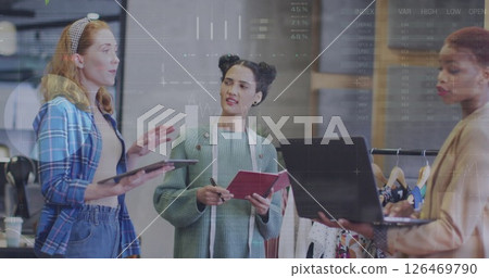 Image of financial data processing over diverse female fashion designers in office 126469790
