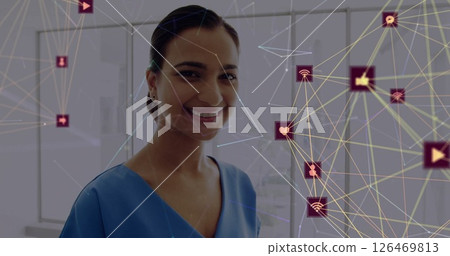 Image of network of connections with icons over biracial female doctor using tablet Image of network of connections with icons over biracial female doctor using tablet 126469813