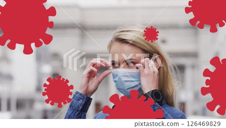 Image of virus cells over caucasian woman wearing face mask Image of virus cells over caucasian woman wearing face mask 126469829