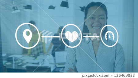 Image of media icons over asian businesswoman smiling in office Image of media icons over asian businesswoman smiling in office 126469888