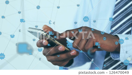 Image of globe of connections with icons over afrcian american businessman using smartphone 126470049