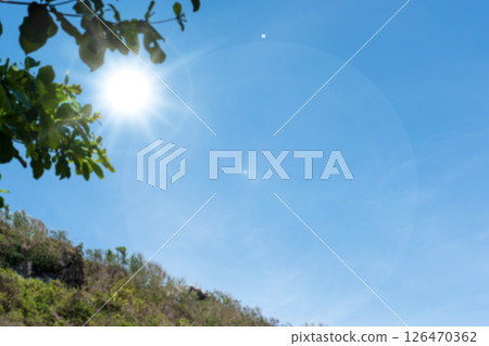 Sunrays or sunlight effect, lens flare, light leaks, overlays, or flare light with tree leaf and blue sky background. Glow, bright, and shine Sunrays or sunlight effect, lens flare, light leaks, overlays, or flare light with tree leaf and blue sky background. Glow, bright, and shine 126470362