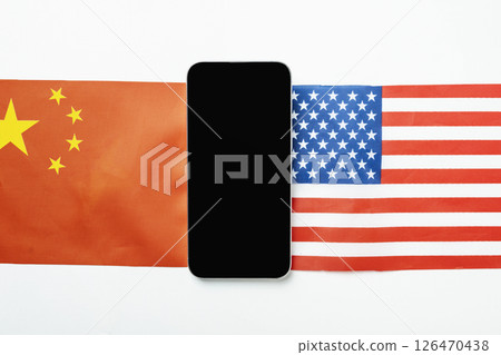 The flags of the USA against China and a cellphone with a blank screen. Mockup or copy space. Concept of the United States of America versus China trade war disputes or economic conflict 126470438