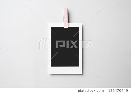 Clothespin with blank polaroid photo paper on a white background. Mockup, template, or copy space. Instant camera photo print frame Clothespin with blank polaroid photo paper on a white background. Mockup, template, or copy space. Instant camera photo print frame 126470449