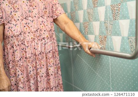 Asian elderly woman use toilet bathroom handle security in toilet. Asian elderly woman use toilet bathroom handle security in toilet. 126471110
