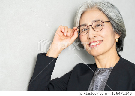 Smiling senior woman in a suit 126471146