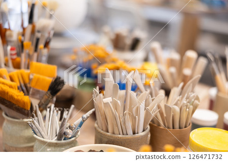 Brushes and tools for sculpting in ceramic workshop Brushes and tools for sculpting in ceramic workshop 126471732