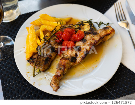 Grilled beef ribs Churasko are garnished with French fries and tomato Grilled beef ribs Churasko are garnished with French fries and tomato 126471872