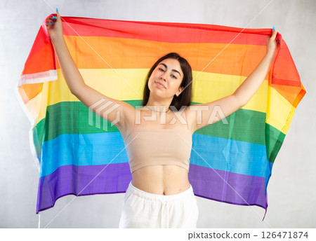 Young woman with LGBT flag posing in studio 126471874