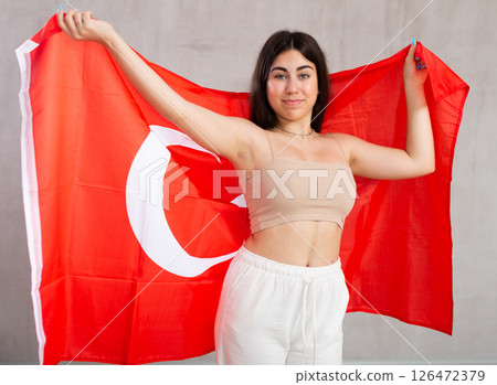 Young woman with Turkey flag posing in studio 126472379