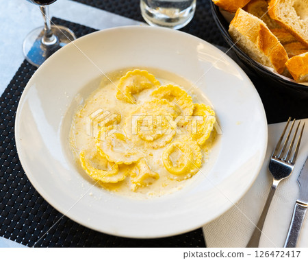 Italian ravioli pasta served with cheese 126472417