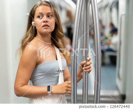 Young girl standing in wagon with wireless headphones on airs Young girl standing in wagon with wireless headphones on airs 126472440