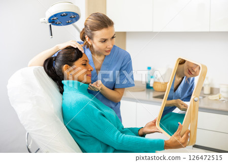Woman having consultation at aesthetic medicine clinic Woman having consultation at aesthetic medicine clinic 126472515
