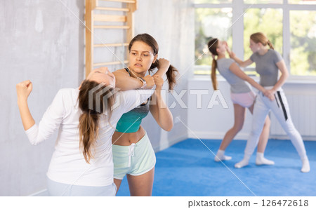 Females practicing self defence moves Females practicing self defence moves 126472618