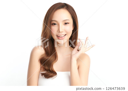 A beautiful young Asian woman with clean, fresh skin against a white background. Skincare, facial treatment, cosmetology, beauty, and spa. An elegant portrait of an Asian woman. A beautiful young Asian woman with clean, fresh skin against a white background. Skincare, facial treatment, cosmetology, beauty, and spa. An elegant portrait of an Asian woman. 126473639
