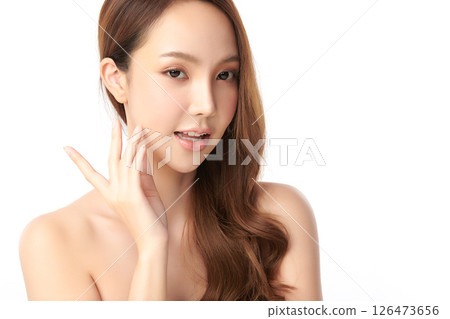 A beautiful young Asian woman with clean, fresh skin against a white background. Skincare, facial treatment, cosmetology, beauty, and spa. An elegant portrait of an Asian woman. 126473656