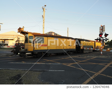 Railgrinder passing through North Street crossing, Rockhampton, Australia Railgrinder passing through North Street crossing, Rockhampton, Australia 126474046